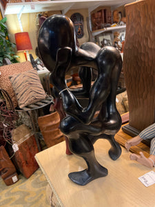 Large African Man Kneeling With Cane