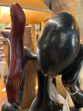 Large African Man Kneeling With Cane