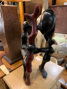 Large African Man Kneeling With Cane
